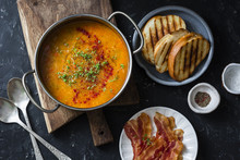 Smoked Paprika Lentil Soup With Grilled Cheese Sandwiches And Crispy Bacon On A Dark Background, Top View. Delicious Comfort Food Concept. Flat Lay