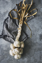 Rustic Moody Garlic Plait On Linen Napkin