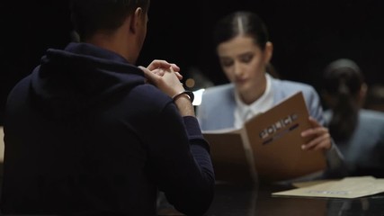 Wall Mural - Thinking woman prosecutor reading criminal case documents, interrogation process