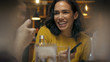© Gorodenkoff - Beautiful Hispanic Woman Uses Smartphone While Talking and Having Fun with Her Friends in the Bar. They Laugh, Joke, Drink in Stylish Hipster Bar Establishment.