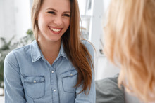 Female Psychologyst Therapy Session With Client Indoors Sitting Patient Smiling Cheerful Close-up