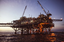 Oil Rig At Sunset With Beautiful Lights