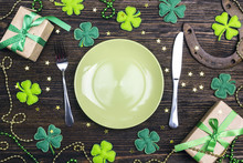 Festive Table Setting For St.Patrick's Day With Cutlery And Lucky Symbols On Wooden Table.