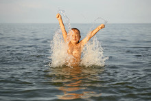 Spray With Water. Girl Having Fun Bathing In The Sea.
