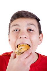 Wall Mural - Young caucasian teenage boy with a sausage roll