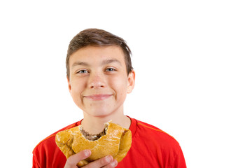 Young caucasian teenage boy eating a pasty