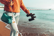 © tinyakov - Unrecognizable Hiking Girl Walks Along The Seashore, With Binoculars. Scout Wanderlust Holidays Concept
