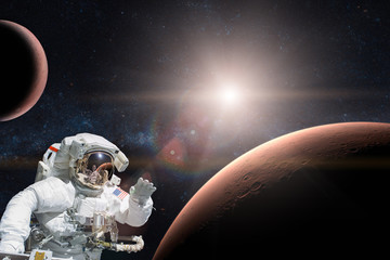 Wall Mural - astronaut in outer space on background of the mars. elements of this image furnished by nasa.