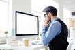 © pressmaster - Serious man looking at monitor display with concentrated facial expression in office