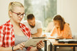 © Voyagerix - Student girl with tablet in front of her classmates