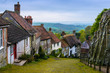 A row of cottages on a steep cobbled street at Gold Hill in Shaftesbury, Dorset, United Kingdom, England. Great Britain