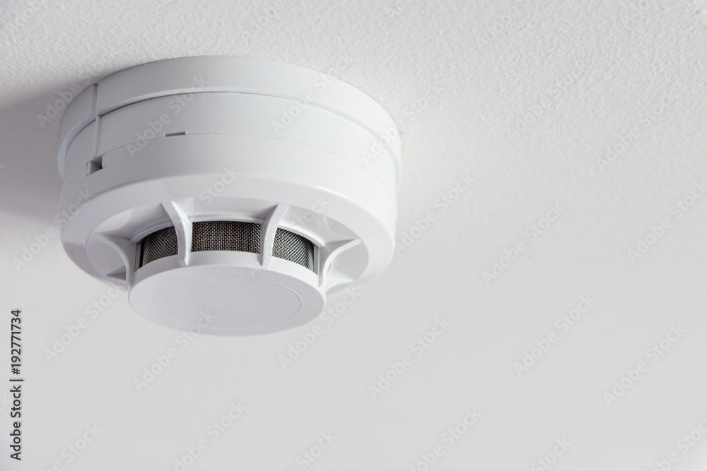 Close up smoke detector on a ceiling. - obrazy, fototapety, plakaty 