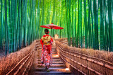 Fototapeta  - Bamboo Forest. Asian woman wearing japanese traditional kimono at Bamboo Forest in Kyoto, Japan.
