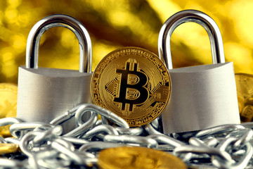 Physical version of Bitcoin (new virtual money), two silver padlocks and chain. Prohibition of cryptocurrencies, regulations, restrictions or security, protection, privacy.