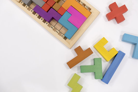 The concept of logical thinking. Geometric shapes on a wooden background. Tetris toy wooden blocks. place for text, Top view flat lay with copy space for slogan or text