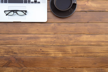 Poster - Flat lay of top view desk work table with computer laptop and stationary in home office on antique brown wood table includes copyspace for add text or graphic