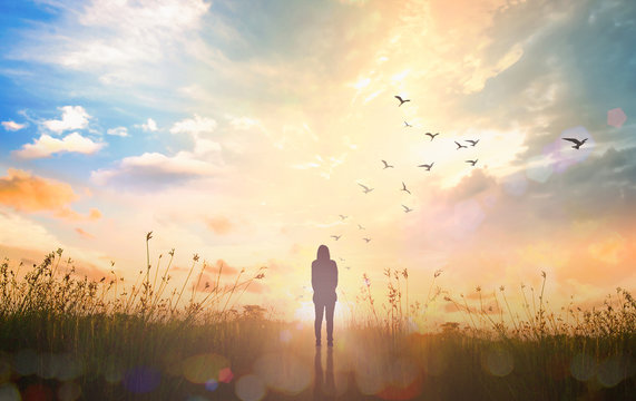 mental health concept: silhouette alone woman standing on abstract of heaven background