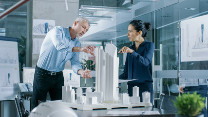 Aufkleber - Two Professional Male and Female Architectural Engineers Work with Blueprints and on a Building Model Design for the Urban Planning Project.Clean Minimalistic Office.