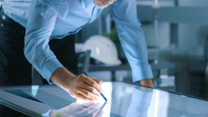 Aufkleber - Senior Architectural Engineer Draws Building Concept on a Graphics Tablet Display Vertical Touchscreen Table. Clean Minimalistic Office, Concrete Walls Covered by Blueprints.