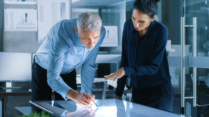 Aufkleber - Senior Male and Young Female Architectural Designers Draw Building Concept on a Graphics Tablet Display Vertical Touchscreen Table. They Use Gestures for Zooming Project Model.