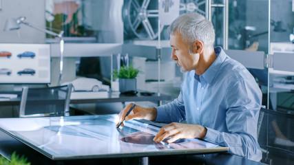 Aufkleber - Experienced Automotive Designer Works With Digital Display Graphics Tablet Touschreen Table, Drawing Sketch of a New Car Prototype.