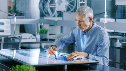 Aufkleber - Experienced Automotive Designer Works With Digital Display Graphics Tablet Touschreen Table, Drawing Sketch of a New Car Prototype.