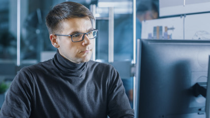 Aufkleber - Young Male Industrial Engineer Works on a Personal Computer. Handsome Smart Man in the Bright Modern Office.