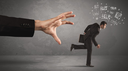 Wall Mural - Business person running away from big hand