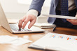 © Prostock-studio - Unrecognizable businessman using laptop and tablet