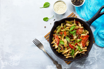 Vitamin lunch with chicken, green beans, arugula, tomatoes and vinaigrette sauce, stone or slate background. Proper nutrition. Healthy lifestyle. Top view.