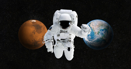 Poster - Astronaut is traveling to a new home on the planet Mars. Spaceman in the open space against the backdrop of the planet Earth and Mars. The concept of future travel