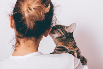close-up of a girl holding a brown cat