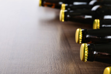 Poster - Fresh beer in glass bottles on wooden background, closeup