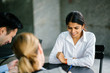 © Danon - A young and attractive Asian Indian woman is being interviewed for a job. Her interviewers are diverse -- one is a Chinese man, the other a Caucasian woman. They are talking in an office and smiling.