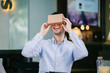 © Danon - Portrait of a happy young Chinese man  trying for the first time on Virtual Reality (VR) goggles. As he looks through the goggles, he's smiling and excited.