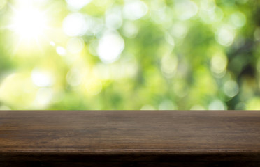 Aufkleber - Empty dark brown hard wood table top with sun and blur green tree bokeh background, Template mock up for montage of product