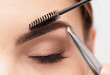 © Africa Studio - Young woman correcting shape of eyebrows, closeup