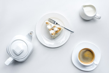 Sticker - top view of appetizing piece of cake with meringue, teapot and coffee on white surface