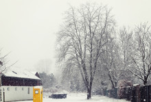 Bavaria Village Under Havy Snowfall With Yellow Post Box