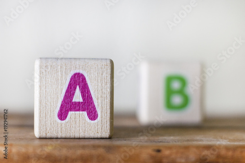 Fotografía Wooden cubes with letters illustrating the sight of myopic people
