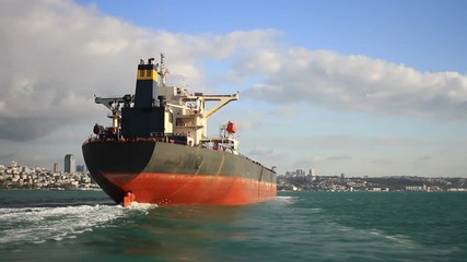 Canvas Print - Stern and funnel of an empty tanker ship sailing into the sea under blue sky. Back view of a 290 meters long crude oil tanker ship on route to Black Sea. Bosporus Straits in Istanbul, Turkey