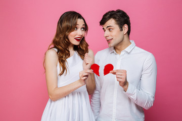 Wall Mural - Happy loving couple holding two halves of heart.