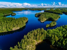 Aerial View Of Blue Lakes And Green Forests On A Sunny Summer Day In Finland.
