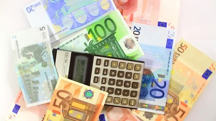 Wall Mural - Calculator on Euro Banknotes spinning clockwise. Money Perfect for any financial, commerce, treasury or banking video needs. Seamless Loop HD Video. 