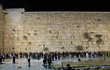 men are praying at the wailing wall in Jerusalem, Israel
