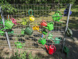 Watering cans on the fence field