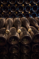 Interior of cellar with bottles of old bottles of champagne