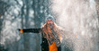 © leszekglasner - Smiling woman throwing snow in the air at sunny winter day