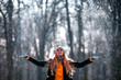 © leszekglasner - Smiling woman throwing snow in the air at sunny winter day