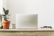 © sonyachny - Laptop on wooden desktop with phone, notebook, coffee cup and plant in stylish modern room. Freelance concept. business workspace in home or office. stylish work place. working online